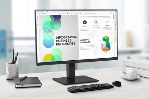Moniteur LG 27BA65QB-B installé sur un bureau avec clavier, souris et accessoires